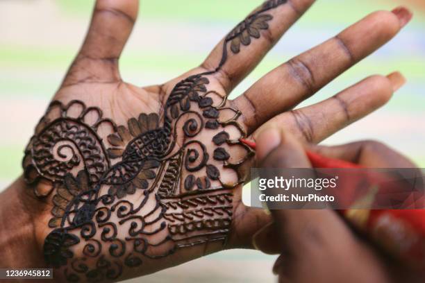 Henna is applied to the hands of a Hindu woman in preparation for the festival of Diwali in Toronto, Ontario, Canada, on November 03, 2021.