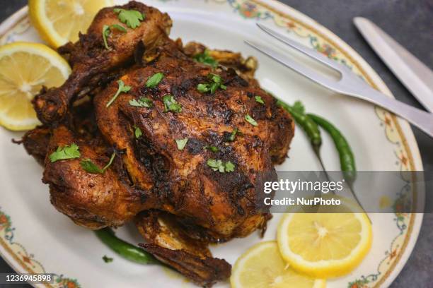 Whole roasted chicken with lemon wedges in Toronto, Ontario, Canada, on November 30, 2021.