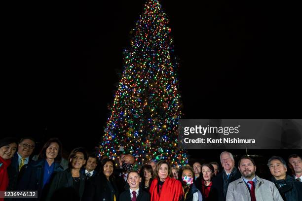 Speaker of the House Nancy Pelosi flanked by members of the California Congressional Delegation stand in front of the Capitol Christmas tree which...