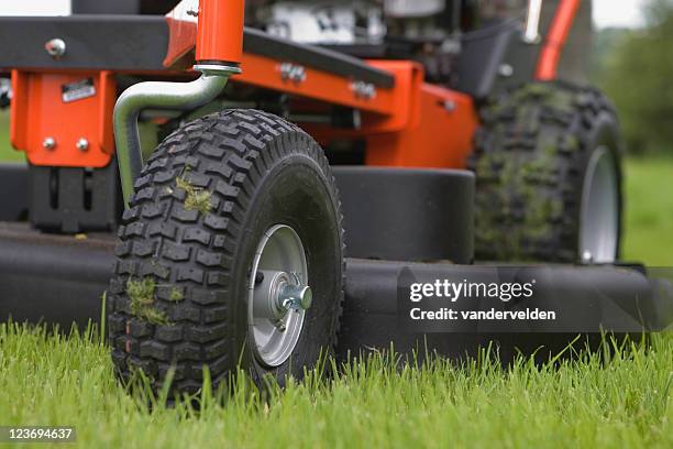 close-up of the wheels and base of a working lawn mower - lawn tractor stock pictures, royalty-free photos & images