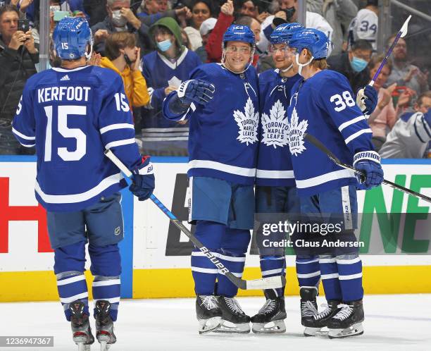 Travis Dermott of the Toronto Maple Leafs celebrates his goal with teammates against the Colorado Avalanche during the second period of the NHL game...