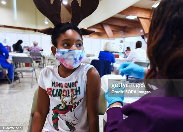 Health worker prepares to administer a dose of Pfizer covid-19 vaccine to a girl at the Sanford Civic Center. With the emergence of the Omicron...