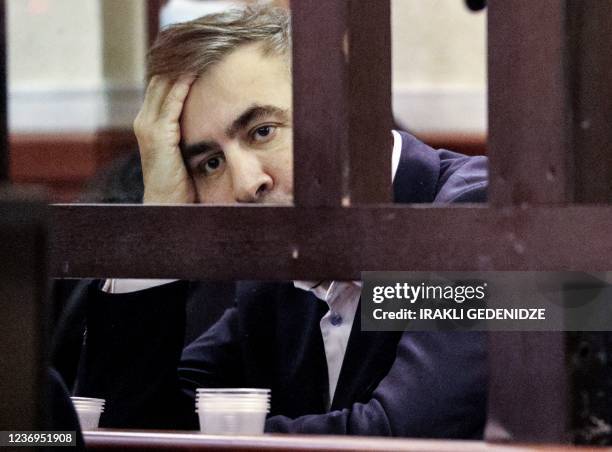 Georgian former President Mikheil Saakashvili sits in the defendant's box during his trial for his alleged role in a violent police crackdown on an...