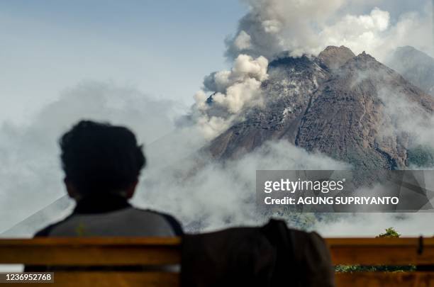 Villager looks at Mount Merapi, Indonesia's most active volcano, as seen from Sleman, on December 2, 2021.