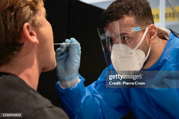 The passenger of a flight from South Africa is tested for the Coronavirus at Amsterdam Schiphol airport on December 2, 2021 in Amsterdam,...