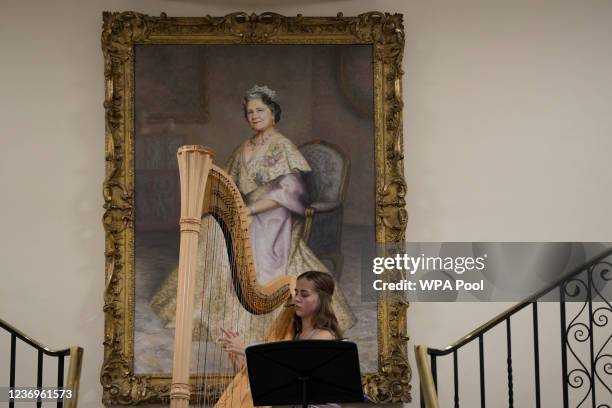 Second year student Liza Rakovska from Ukraine plays the harp beneath a portrait of Britain's Queen Elizabeth the Queen Mother, while guest await the...
