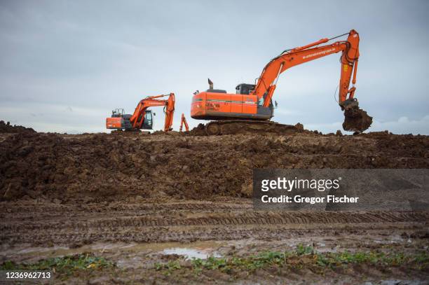 Two excavators at the construction site of the new Fehmarn Belt Fixed Link tunnel on Fehmarn island on December 2, 2021 near Puttgarden, Germany. The...