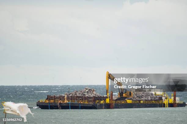 An excavator stands at the construction site of the new Fehmarn Belt Fixed Link tunnel on Fehmarn island on December 2, 2021 near Puttgarden,...