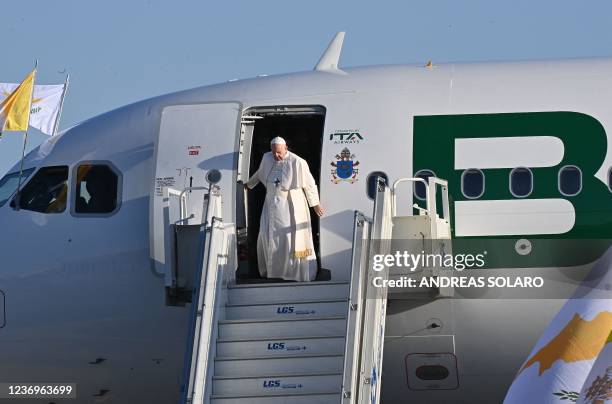 Pope Francis disembarks from the plane upon his arrival in the southern Cypriot port city of Larnaca on December 2, 2021 at the start of a landmark...