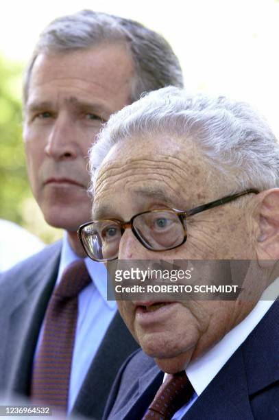 Texas Governor and Republican presidential candidate George W. Bush listens as former US Secreatary of State Henry Kissinger answers a question to...