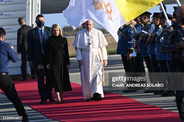 Pope Francis walks on the Red Carpet with Cypriot Parliament Speaker Annita Demetriou upon his arrival in the southern port city of Larnaca on...