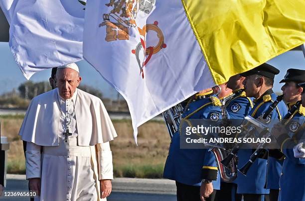 Pope Francis walks on the Red Carpet upon his arrival in the southern port city of Larnaca on December 2, 2021 at the start of a landmark trip to...