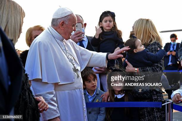 Pope Francis greets people upon his arrival in the southern Cypriot port city of Larnaca on December 2, 2021 at the start of a landmark trip to push...