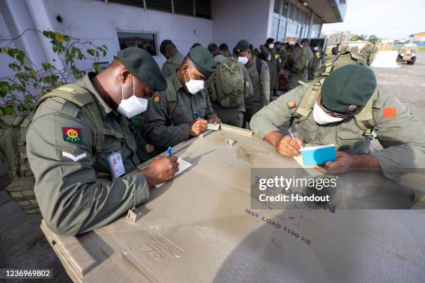 In this handout provided by the Australian Department of Defence, Republic of Fiji Military Force soldiers fill in immigration certificates at...