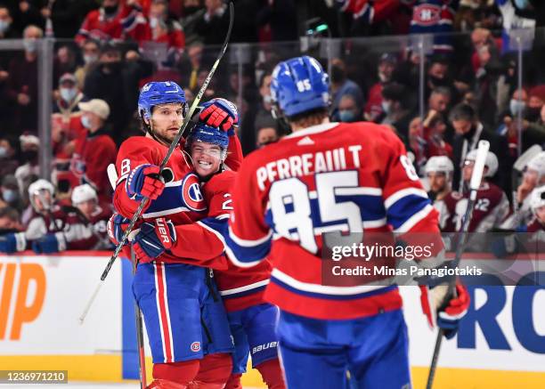 Ben Chiarot of the Montreal Canadiens celebrates his goal with teammates Cole Caufield and Mathieu Perreault during the second period against the...