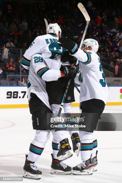 Erik Karlsson of the San Jose Sharks is congratulated by Timo Meier and Logan Couture after scoring the game-winning goal against the New York...