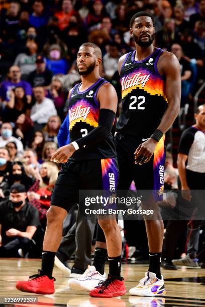 Chris Paul and Deandre Ayton of the Phoenix Suns look on during the game against the Detroit Pistons on December 2, 2021 at Footprint Center in...