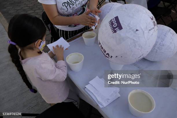 Inhabitants of Iztapalapa, Mexico City, in the Territorial Estrella Huizachtépetl who participated in a workshop to make piñata bases out of...