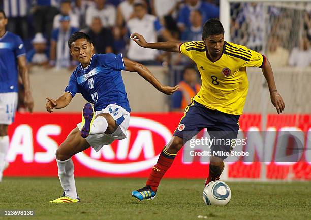 Cristian Marrugo of Colombia plays the ball in front of Andy Najar of Honduras during an International Friendly on September 3, 2011 at Red Bull...