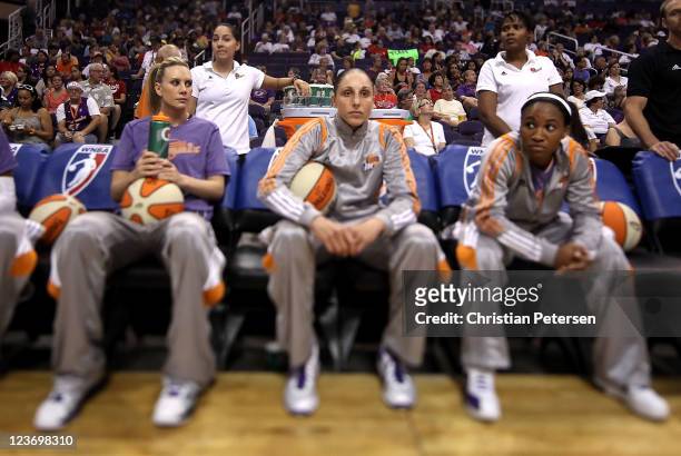 Diana Taurasi of the Phoenix Mercury sits on the bench with Penny Taylor and Temeka Johnson before the WNBA game against the Los Angeles Sparks at US...