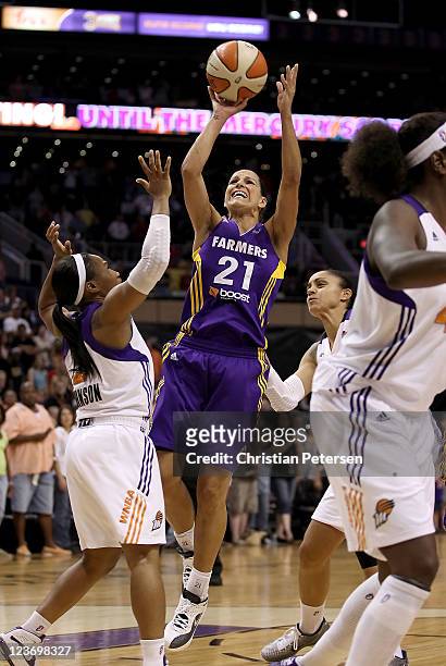 Ticha Penicheiro of the Los Angeles Sparks puts up a shot over Temeka Johnson of the Phoenix Mercury during the WNBA game at US Airways Center on...