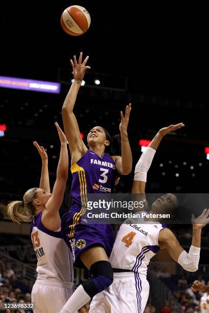 Candace Parker of the Los Angeles Sparks puts up a shot between Penny Taylor and Candice Dupree of the Phoenix Mercury during the WNBA game at US...