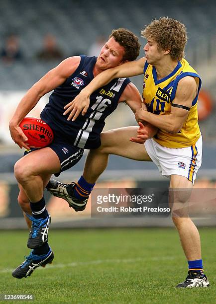 Tom Watson of the Falcons is tackled by Daniel Castellano of the Jets during the Elimination Final match between the Western Jets and the Geelong...