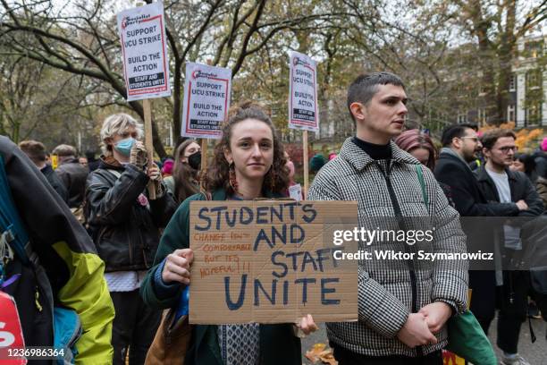 Demonstrator holds a placard as lecturers, trade unionists and students gather for a rally in Tavistock Square before marching in solidarity with...