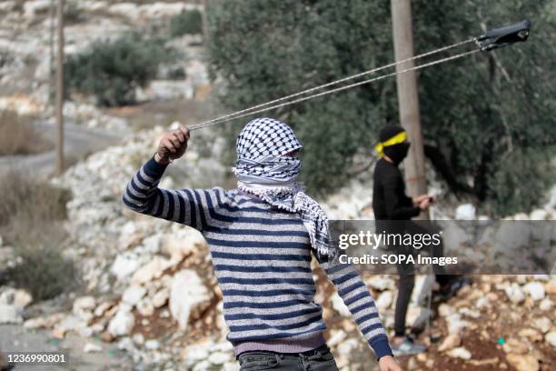 Palestinian seen throwing stones using a slingshot, during clashed with the Israeli army. Palestinians have been protesting every Friday and Saturday...