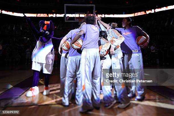 The Phoenix Mercury huddle up as they are introduced to the WNBA game against the Los Angeles Sparks at US Airways Center on September 3, 2011 in...