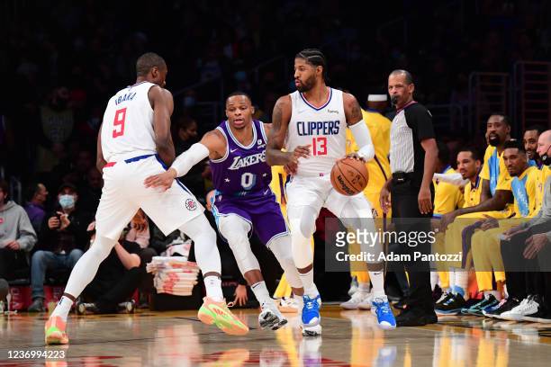 Paul George of the LA Clippers handles the ball against Russell Westbrook of the Los Angeles Lakers during the game on December 3, 2021 at STAPLES...