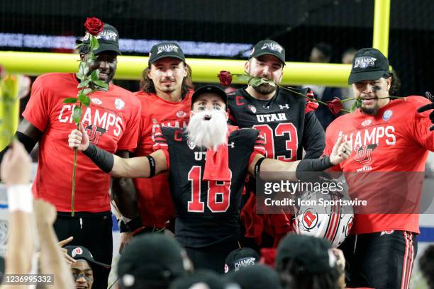 Wide receiver Britain Covey of the Utah Utes wears a white beard as he and teammates pose for photos with roses after the Utes secured a spot in the...