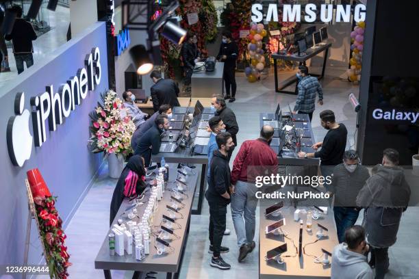 Logos of the Apple American company and the Samsung South Korean company are pictured in an IT-City multi brand shop at the Paytakht computer centre...