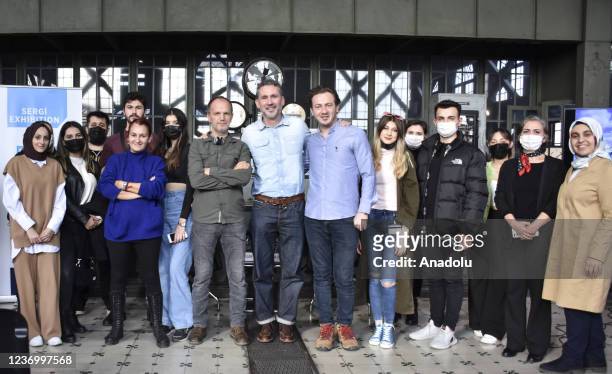 Adam Pretty , a photojournalist with Getty Images, poses for a photo with participants at a special Istanbul exhibition of selections from the...