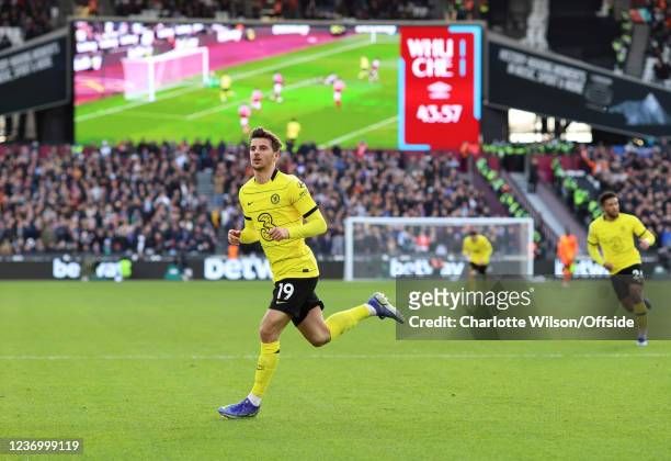 Mason Mount of Chelsea celebrates his volleyed goal which is still being shown on the delayed screen during the Premier League match between West Ham...