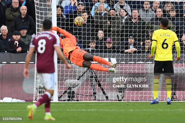 West Ham United's French defender Arthur Masuaku scores his team's third goal past Chelsea's French-born Senegalese goalkeeper Edouard Mendy during...