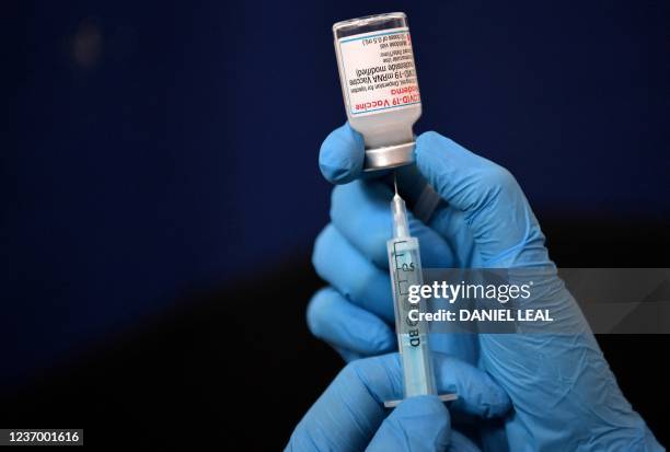 Clinician prepares a dose of a Moderna Covid-19 booster vaccine at a temporary vaccination centre set up inside St John's Church in west London on...