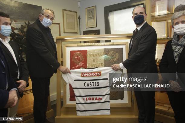 France's Prime Minister Jean Castex receives a rugby jersey from French former player and vice president of CA Brive Rugby Jean Luc Joinel during a...