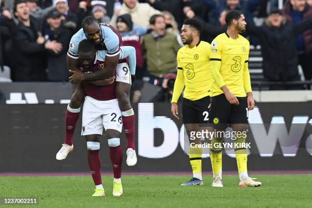 West Ham United's French defender Arthur Masuaku celebrates with West Ham United's English midfielder Michail Antonio after he scores his team's...