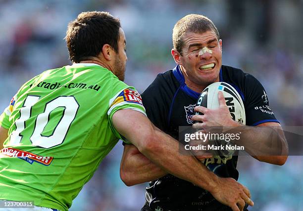 Andrew Ryan of the Bulldogs is tackled during the round 26 NRL match between the Canterbury-Bankstown Bulldogs and the Canberra Raiders at ANZ...