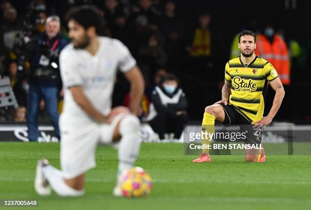 Watford's Spanish defender Kiko Femenia takes the knee in support of the No Room For Racism campaign during the English Premier League football match...