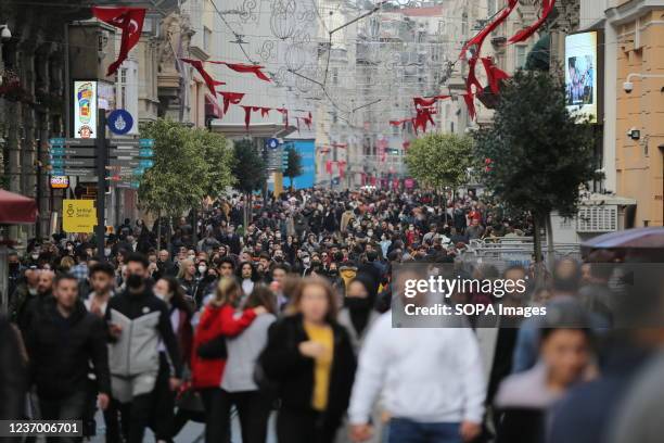 Dozens of people walk along the Istiklal Avenue in Beyoglu district, one of the most famous shopping places in Istanbul.