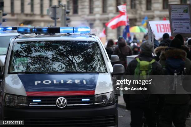 Police take measures as people gather to protest against vaccination requirement and coronavirus measures despite the curfew imposed throughout the...