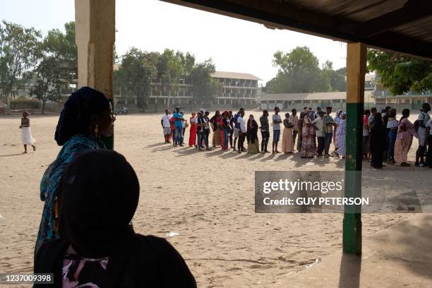 Voters wait in line to cast their vote at a polling station in Serrekunda school in Banjul on December 4, 2021. - Gambians were due to head to the...