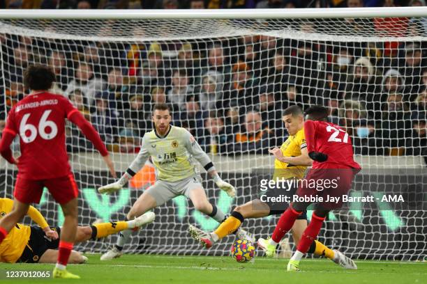 Divock Origi of Liverpool scores a goal to make it 0-1 during the Premier League match between Wolverhampton Wanderers and Liverpool at Molineux on...