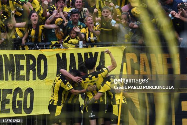 Peñarol's Agustin Canobbio celebrates with teammates after scoring against Sud America during the Uruguayan Clausura tournament at the Campeon del...