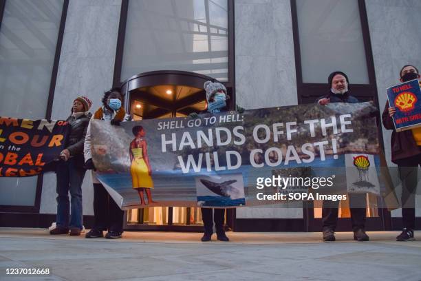 Activists hold a 'Hands Off The Wild Coast' banner during the demonstration. Protesters gathered outside the Shell headquarters in London, in protest...