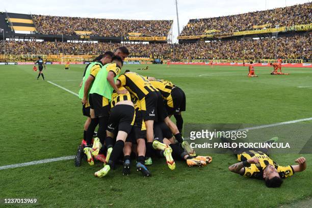 Peñarol's Jesus Trindade celebrates with teammates after scoring against Sud America during the Uruguayan Clausura tournament at the Campeon del...