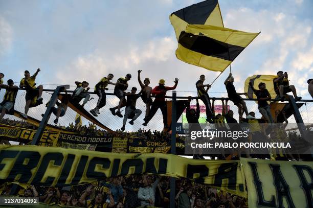 Fans of Peñarol celebrate after winning the Uruguayan Clausura tournament at the Campeon del Siglo stadium in Bañados de Carrasco, Uruguay on...