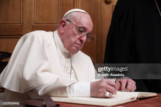 Pope Francis writes on the formal book of the Archdiocese of Athens during his meeting with Archbishop Ieronymos II of Athens and All Greece, at Holy...